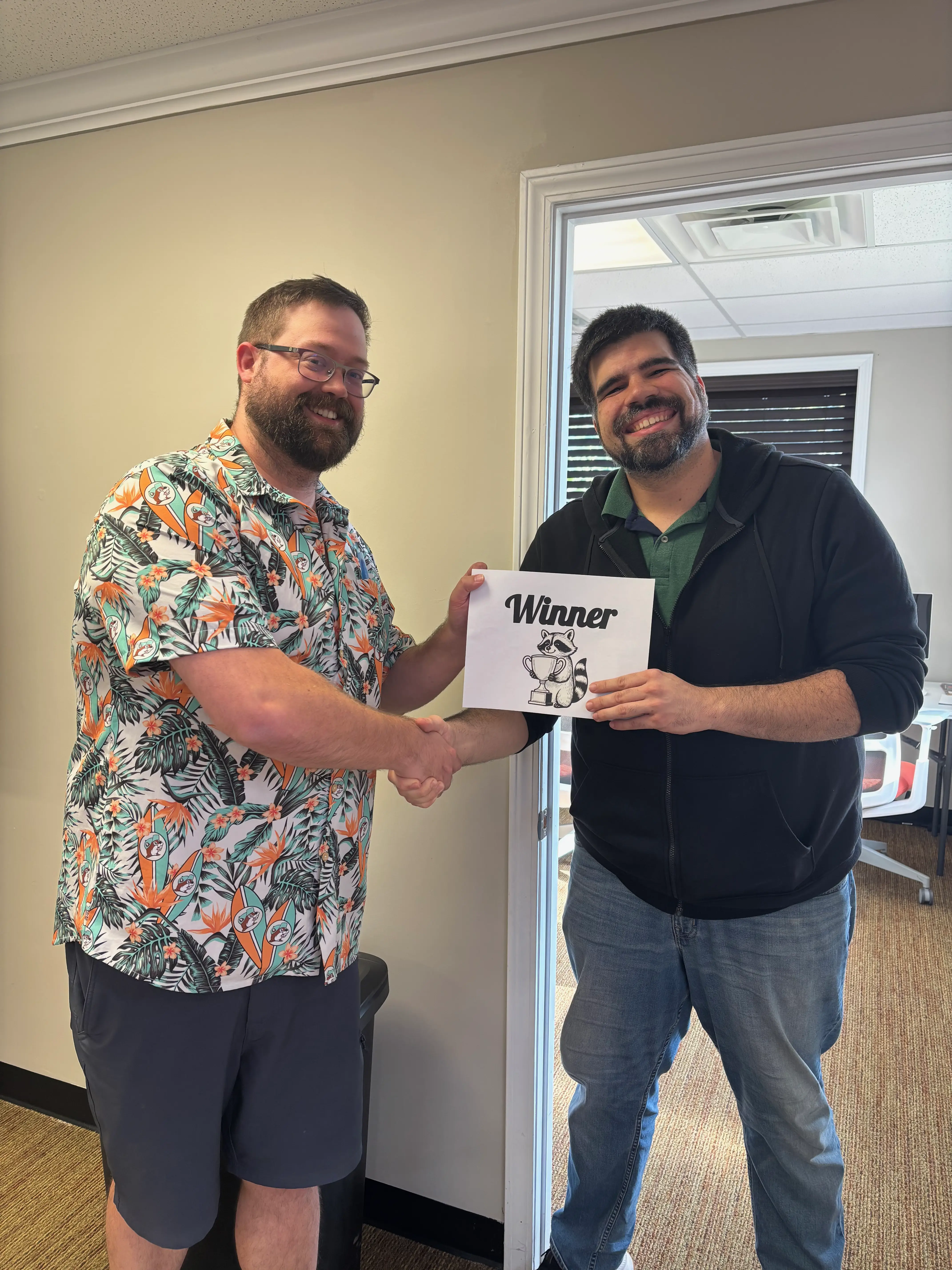Tournament Director Alex Gustafson awarding a Winner's certificate and cash prize to event winner Jacob Johnson.